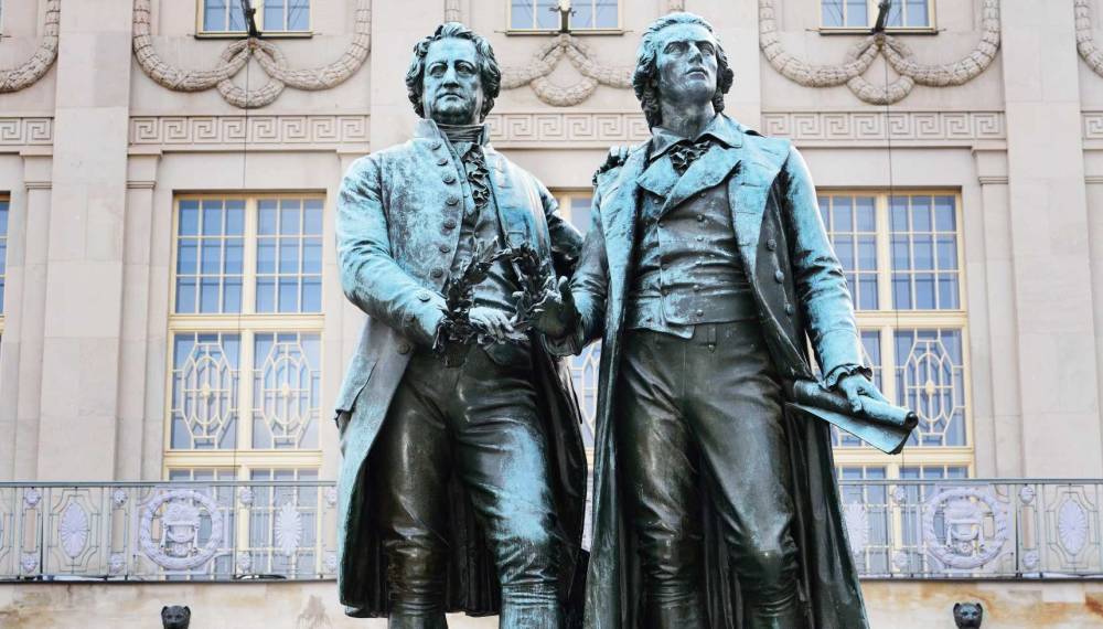 Bronzestatue von Goethe und Schiller vor dem Deutschen Nationaltheater in Weimar.