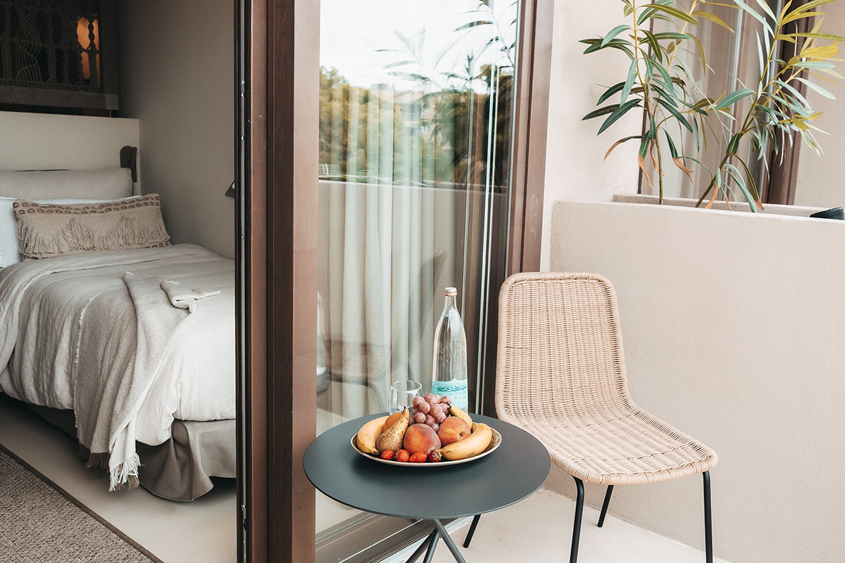 Balkon des gemütlichen Hotelzimmers Dormitorio mit Sitzgelegenheit und Snacks im Barefoot Hotel Mallorca.