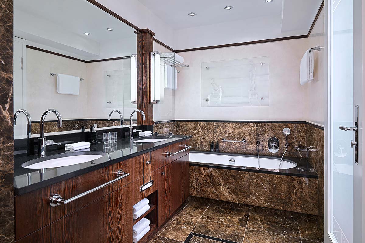 Bathroom of the Walter-Gropius-Suite in the Hotel Elephant Weimar with modern furnishings, marble elements and large bathtub.