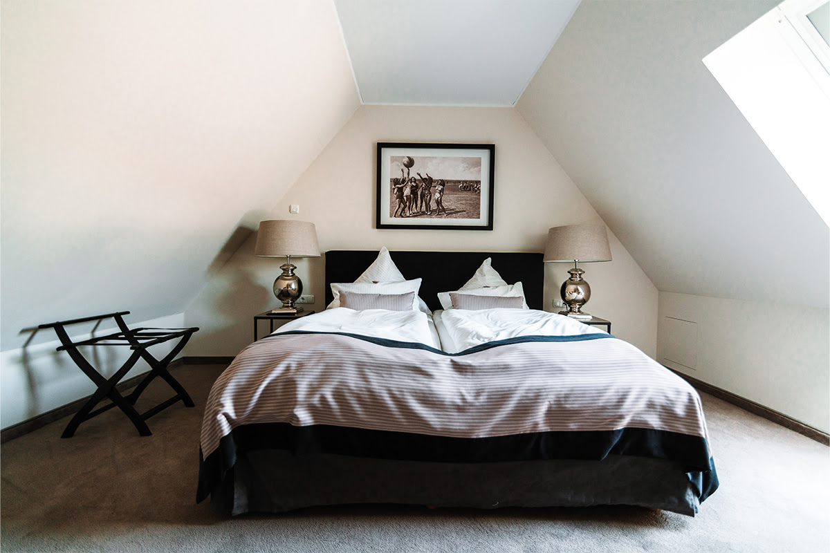 Gemütliches Schlafzimmer mit Doppelbett in der Ferienwohnung Strandperle, Teil des Hotels Künstlerquartier Seezeichen.