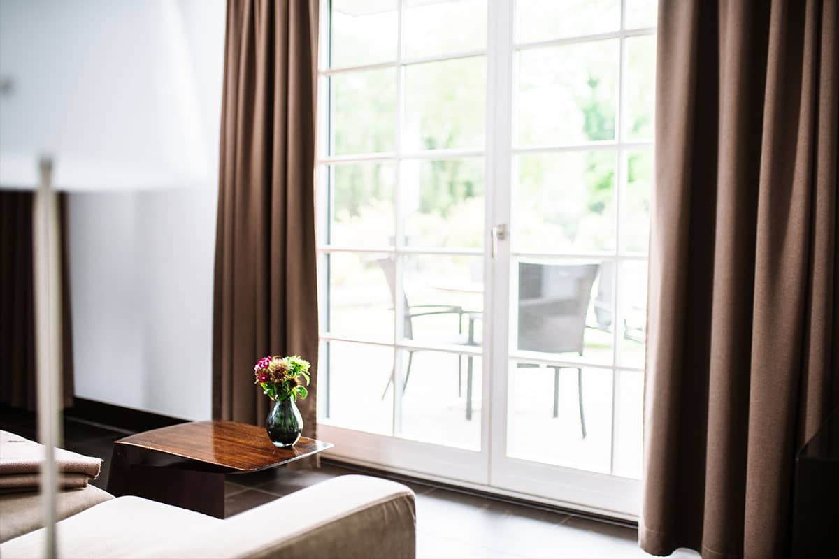 Inviting view outside through the window front of the Junior Suite in the Hotel Künstlerquartier Seezeichen with a cozy ambience.