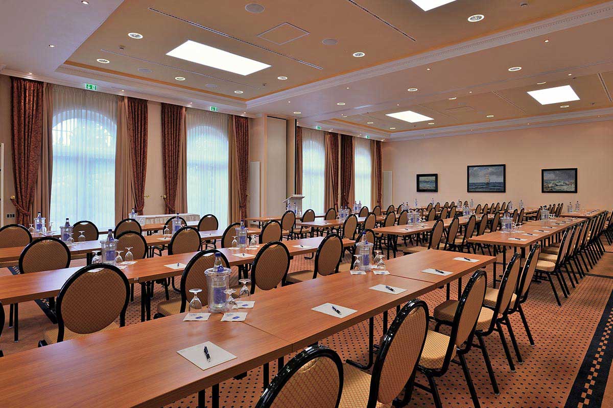 Konferenzraum des Vju Hotels, ausgestattet mit Tischen, Stühlen, Wasser und Schreibmaterial, ideal für Tagungen